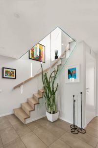 Designtrapp med underliggende vange, boltet glassrekkverk uten håndløper Designtrapp med underliggende vange og boltet glassrekkverk