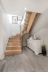 Designtrapp med sentervange, alle trappens deler i parkettmønstret eik. Tette trinn uten trappenese. Boltet glassrekkverk med håndløper i eik. Designtrapp med sentervange, alle trappens deler i parkettmønstret eik. Boltet glassrekkverk med håndløper i eik.